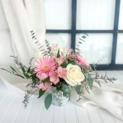 Pink and white bouquet in a small white vase