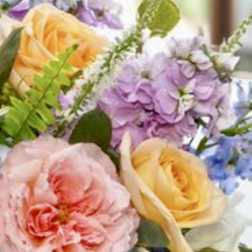 Pastel bouquet with pink, yellow, purple, and blue flowers