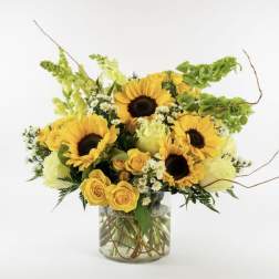 Sunflower and yellow rose bouquet in a clear glass vase