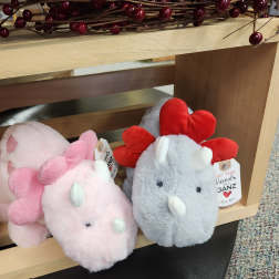 Plush dinosaur toys in pink and gray with heart-shaped spikes