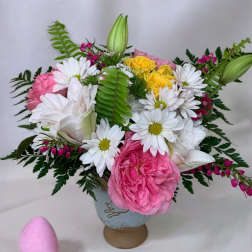 Pink and white flower arrangement with daisies and roses in a vase