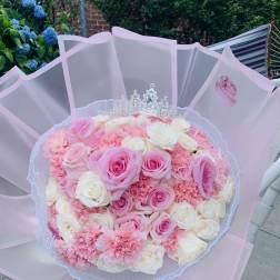 Pink and white rose bouquet with a silver tiara topper