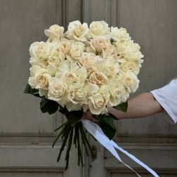 Bouquet of cream roses tied with a white ribbon