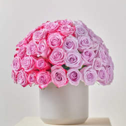 Round bouquet of pink roses in a white vase