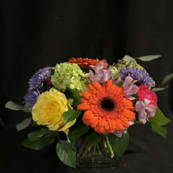 Colorful mixed bouquet in a clear glass vase