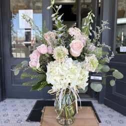 Pink roses and white hydrangeas in a glass vase