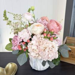Pink and white floral arrangement in a white vase