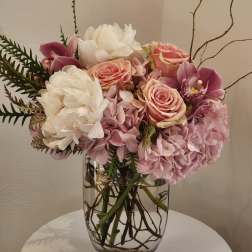 Pink and white floral arrangement in a clear glass vase
