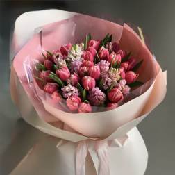 Pink tulip bouquet wrapped in pale pink paper with a ribbon