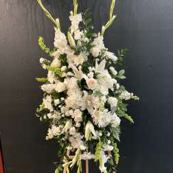 Tall white floral standing spray on an easel