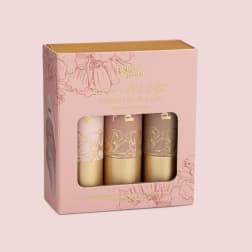 Pink boxed set of three jumbo lip tints with floral illustrations and a clear window.