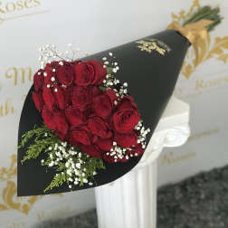 Bouquet of red roses with baby's breath in black wrap