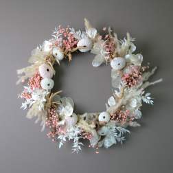 Circular floral wreath with pale pink and white dried flowers