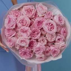 Bouquet of pink roses wrapped in pale pink paper