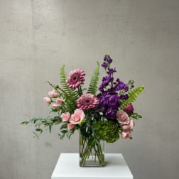 Pink and purple mixed bouquet in a clear glass vase