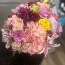 Mixed bouquet of pink, purple, yellow, and peach flowers