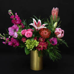 Pink and magenta mixed bouquet in a gold vase