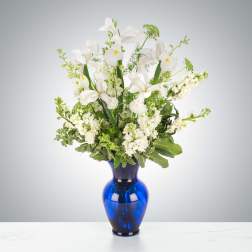 White iris arrangement in a cobalt blue vase