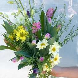 Mixed bouquet with yellow daisies, pink tulips, and white blooms