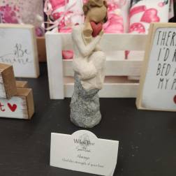 Small Willow Tree figurine of a seated figure holding a red heart