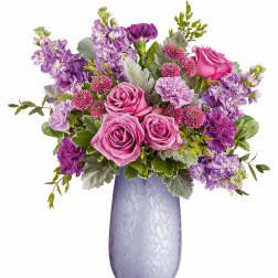 Pink and purple flower arrangement in a lavender vase