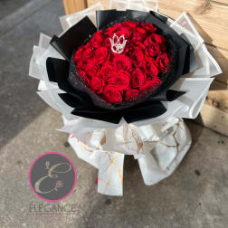 Bouquet of red roses wrapped in black and white paper