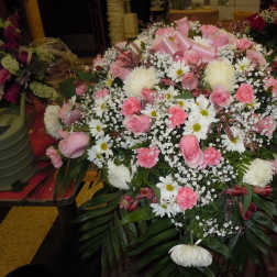 Large pink and white floral spray with ribbon accents