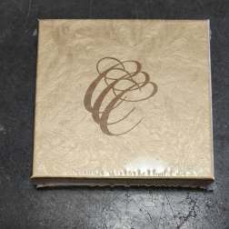 Gold decorative gift box with a brown abstract swirl design