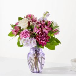 Pink and white mixed bouquet in a purple glass vase