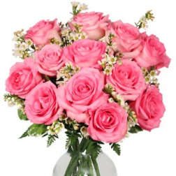 Pink roses arranged in a clear glass vase