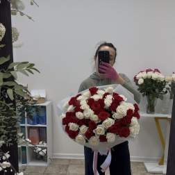 Large bouquet of red and white roses wrapped in white paper