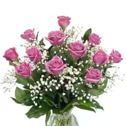 Pink roses in a glass vase with white baby's breath