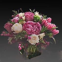 Pink and white bouquet in a clear glass vase