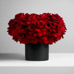 Red rose bouquet in a black cylindrical vase