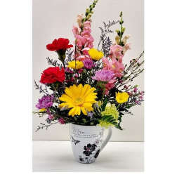 Colorful mixed bouquet in a white mug vase