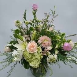 Mixed pastel flower arrangement in a glass vase