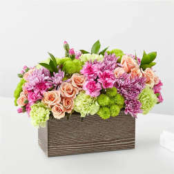 Mixed pink and green floral arrangement in a rectangular wooden box