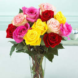 Bouquet of multicolored roses in a clear glass vase