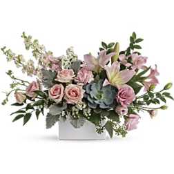 Low rectangular arrangement of pink roses and lilies with a blue-green succulent in a white vase
