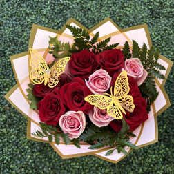 Bouquet of red and pink roses with gold butterfly decorations