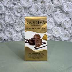 A box of Godiva assorted chocolates on a table.