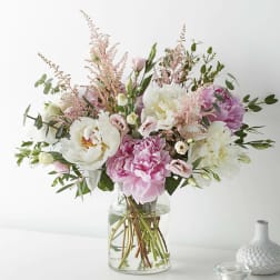 Pink and white bouquet in a clear glass vase
