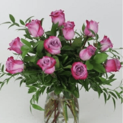 Pink roses arranged in a clear glass vase