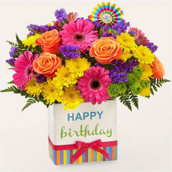 Bright mixed bouquet in a birthday gift box with a ribbon