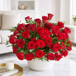 Large bouquet of red roses in a white textured vase