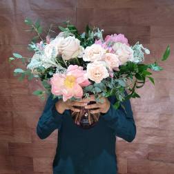 Large bouquet of pale pink and white roses in a glass vase