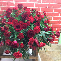 Large red floral arrangement with roses and carnations