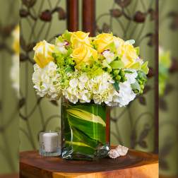 Yellow roses and white hydrangeas in a glass vase
