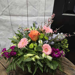 Mixed bouquet with pink gerberas, orange rose, and purple blooms