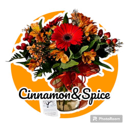 Bouquet with a red gerbera daisy and orange flowers in a glass vase